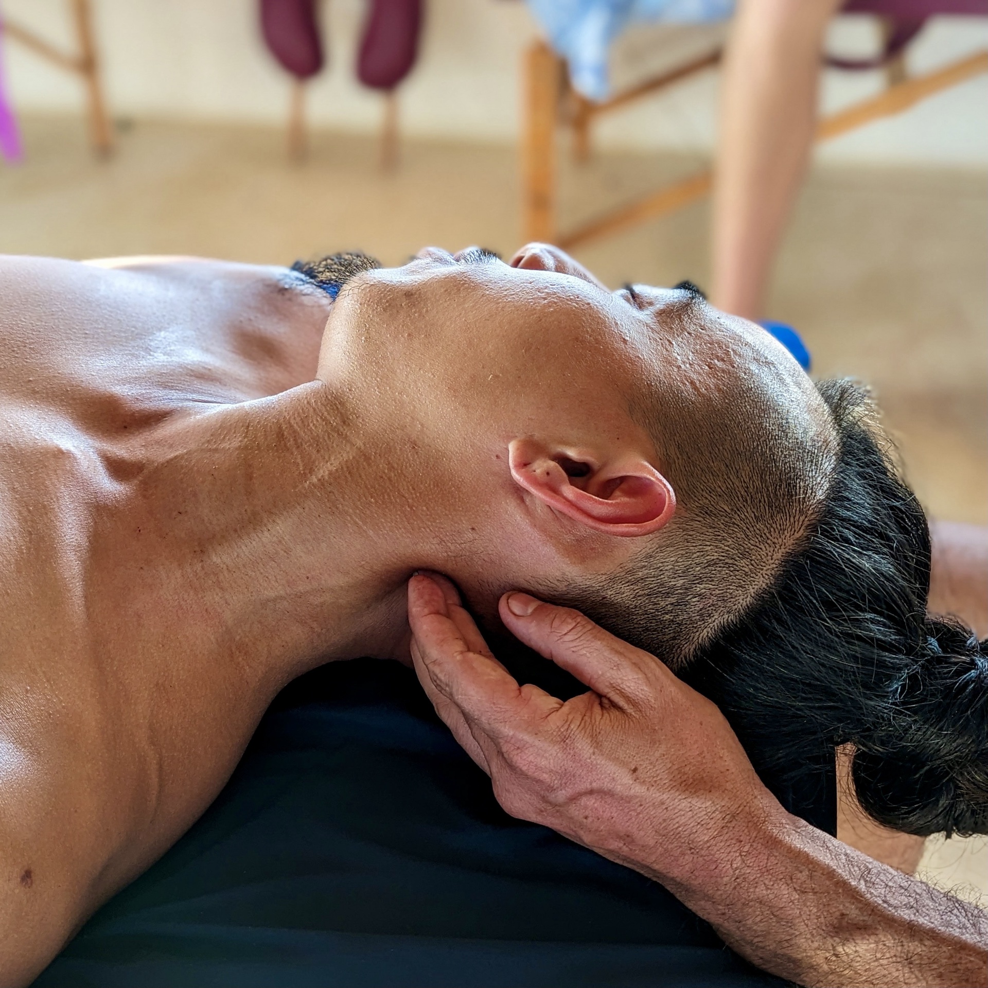 Close-up of hands working on the neck demonstrating the ease and simplicity of deep bodywork