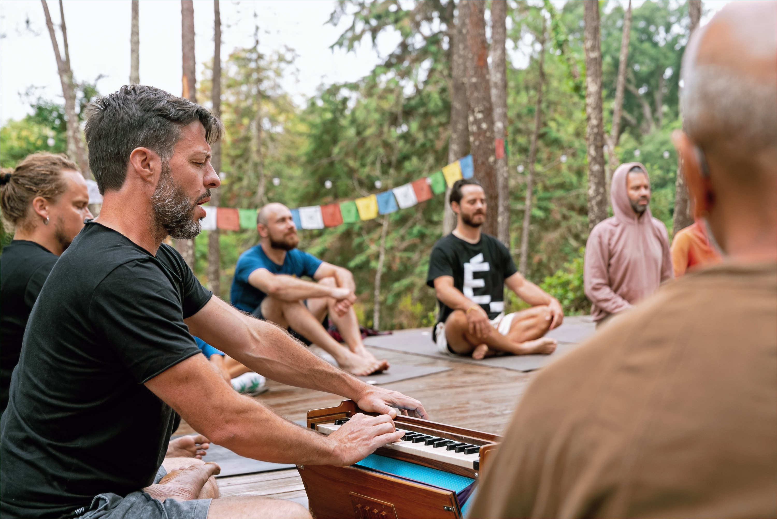 Group yoga and breathwork practice outdoors during the training
