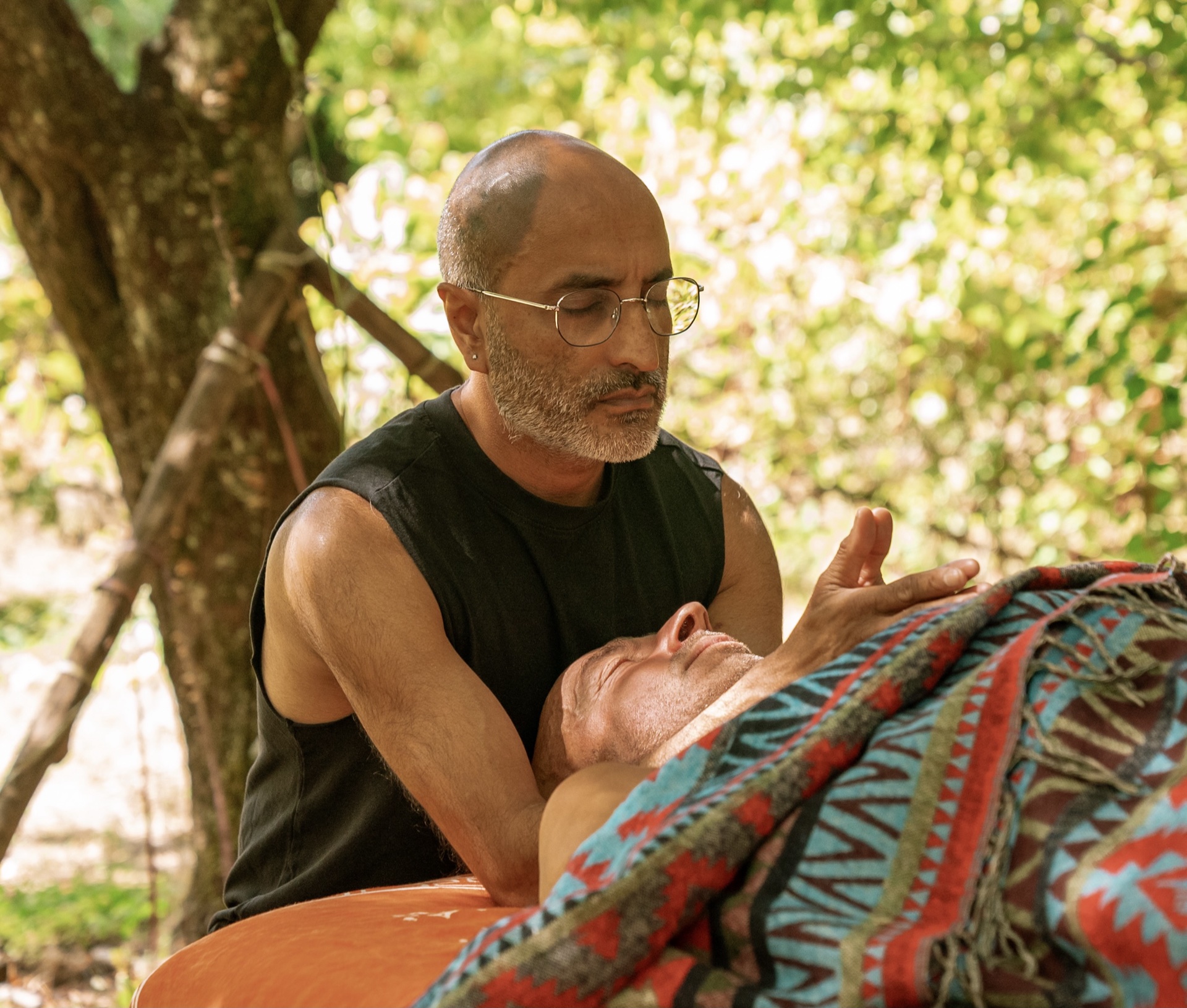 Participants learning bodywork in an outdoor natural setting